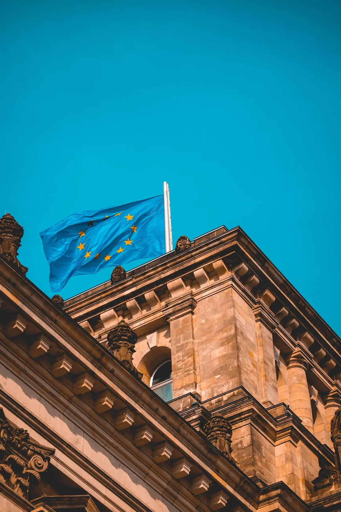 European union flag waving on building roof